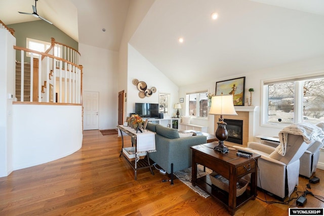 living room featuring hardwood / wood-style flooring, high vaulted ceiling, a wealth of natural light, and ceiling fan