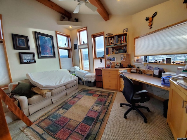 office space with beamed ceiling, built in desk, light colored carpet, and ceiling fan