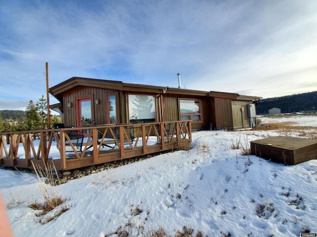 snow covered property featuring a deck