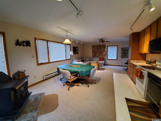 dining room with rail lighting, baseboard heating, ceiling fan, and pool table