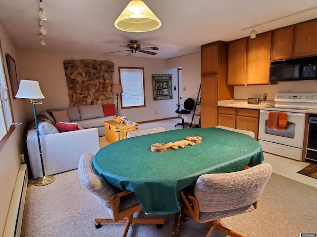 interior space featuring ceiling fan, baseboard heating, and rail lighting