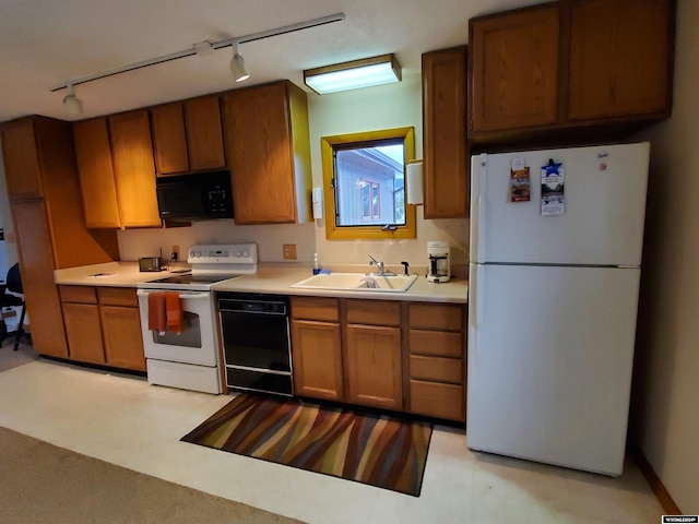 kitchen featuring sink, black appliances, and track lighting