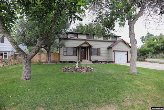 view of front of property featuring a garage and a front lawn