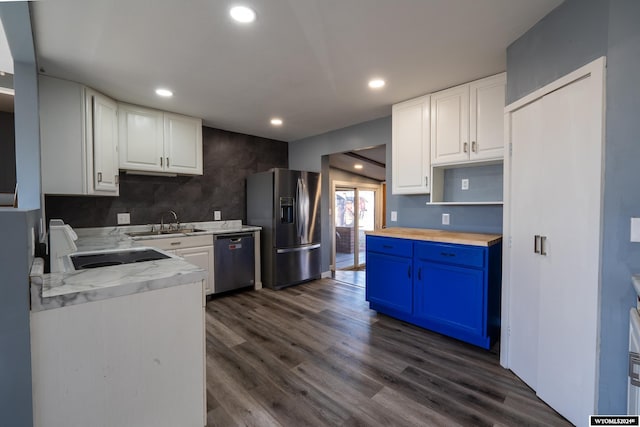 kitchen featuring sink, stainless steel appliances, dark hardwood / wood-style floors, blue cabinets, and white cabinets