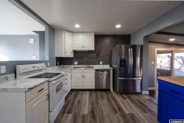 kitchen with white cabinets, dark hardwood / wood-style flooring, sink, and appliances with stainless steel finishes