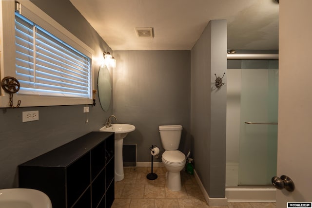 bathroom featuring sink, toilet, and walk in shower