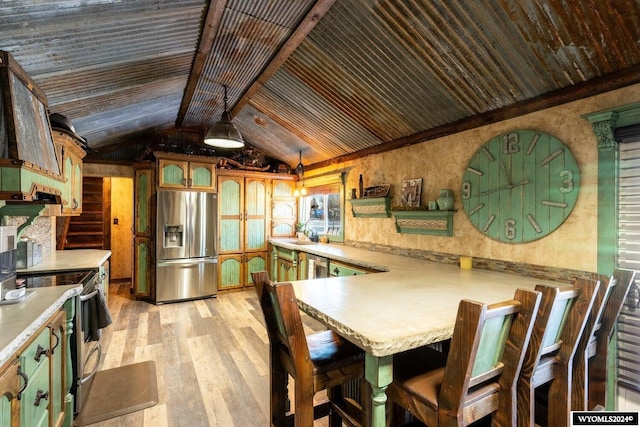 kitchen featuring pendant lighting, a breakfast bar, light hardwood / wood-style flooring, appliances with stainless steel finishes, and kitchen peninsula