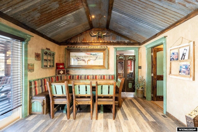 dining space featuring wooden ceiling, hardwood / wood-style floors, a healthy amount of sunlight, and vaulted ceiling