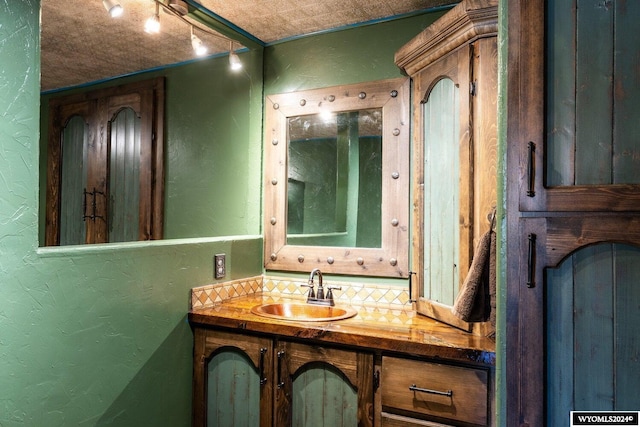 bathroom featuring vanity and tasteful backsplash