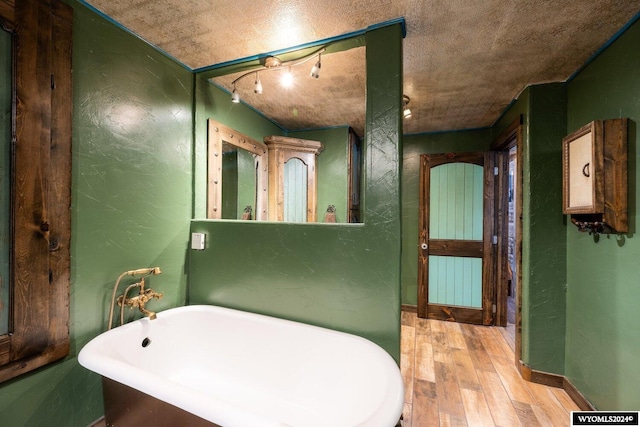 bathroom featuring hardwood / wood-style floors and a bath