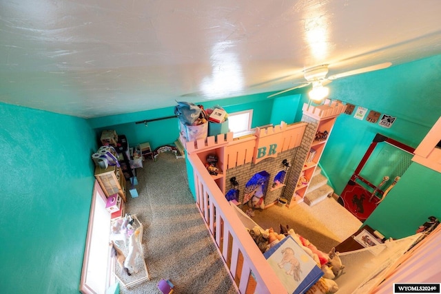 interior space featuring carpet flooring and ceiling fan