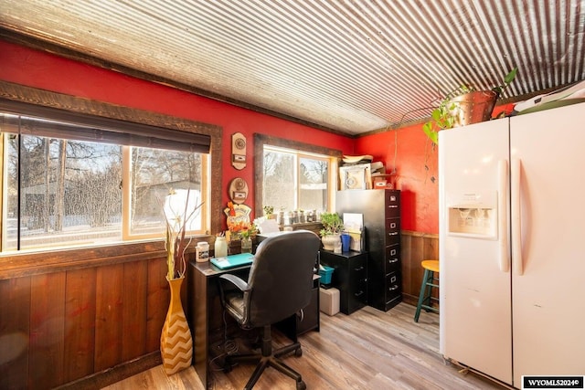 office with wood walls and hardwood / wood-style floors