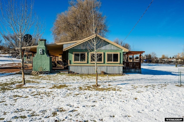 view of snow covered rear of property