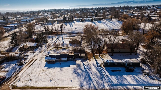 snowy aerial view with a mountain view