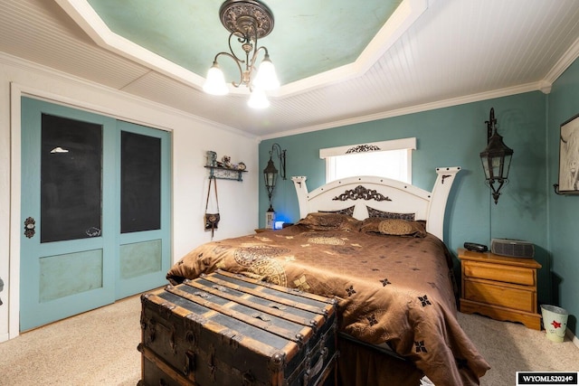 bedroom featuring a tray ceiling, crown molding, and carpet floors