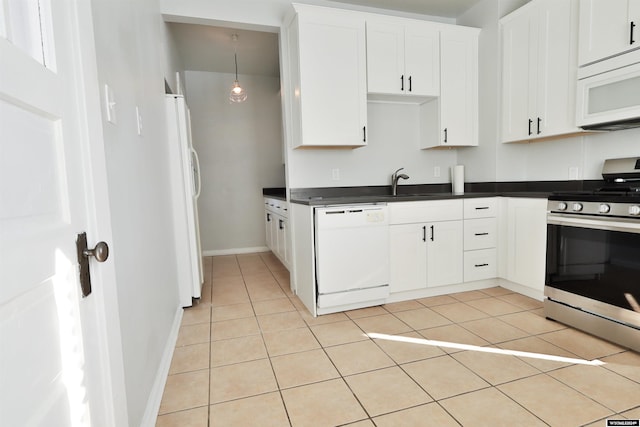 kitchen featuring sink, white cabinets, light tile patterned flooring, and white appliances