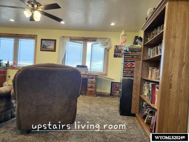 interior space with ceiling fan