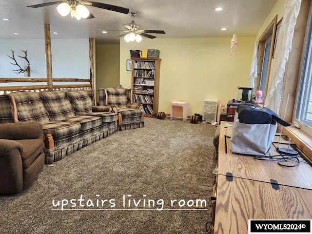 carpeted living room featuring ceiling fan