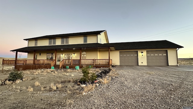 farmhouse with a garage and covered porch