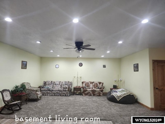 carpeted living room with ceiling fan