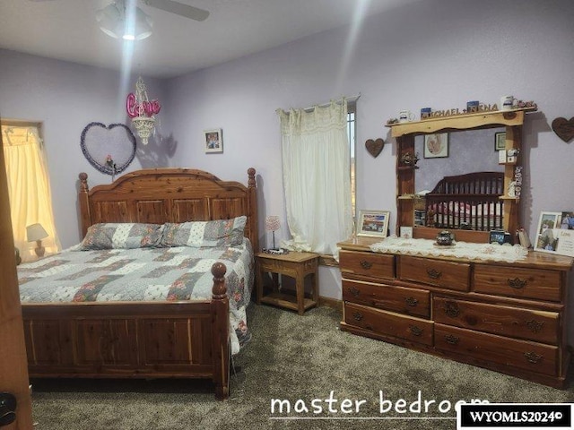 bedroom featuring dark colored carpet and ceiling fan