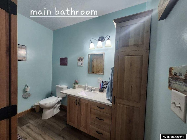 bathroom featuring hardwood / wood-style floors, vanity, and toilet