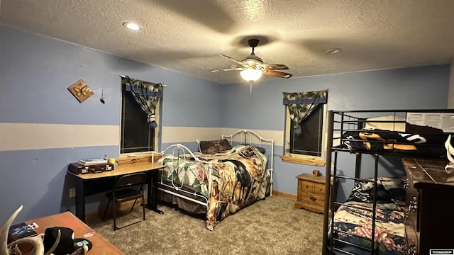 bedroom with carpet flooring, ceiling fan, and a textured ceiling