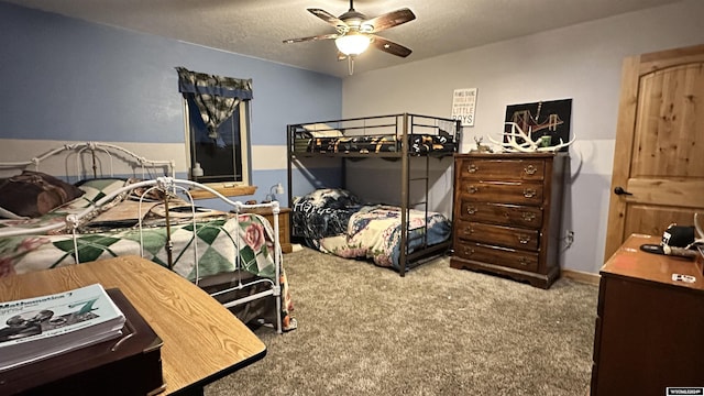 carpeted bedroom with ceiling fan and a textured ceiling