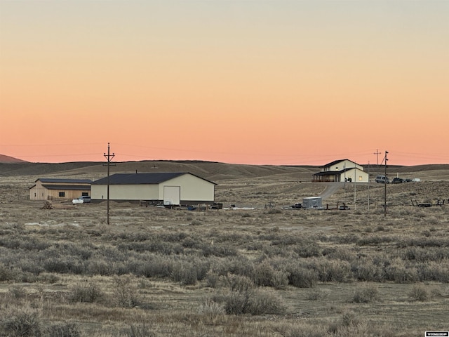 yard at dusk with a mountain view and central AC