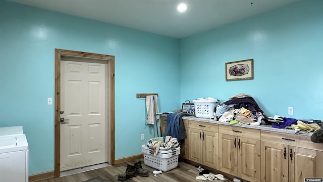 laundry area with hardwood / wood-style flooring, cabinets, and washer / clothes dryer