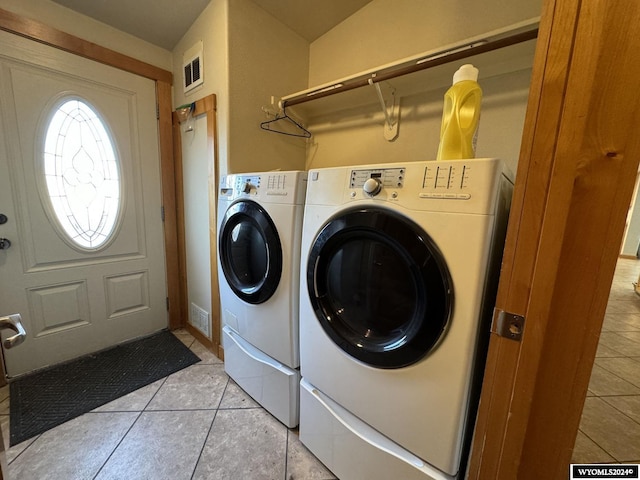 laundry area featuring light tile patterned floors and independent washer and dryer