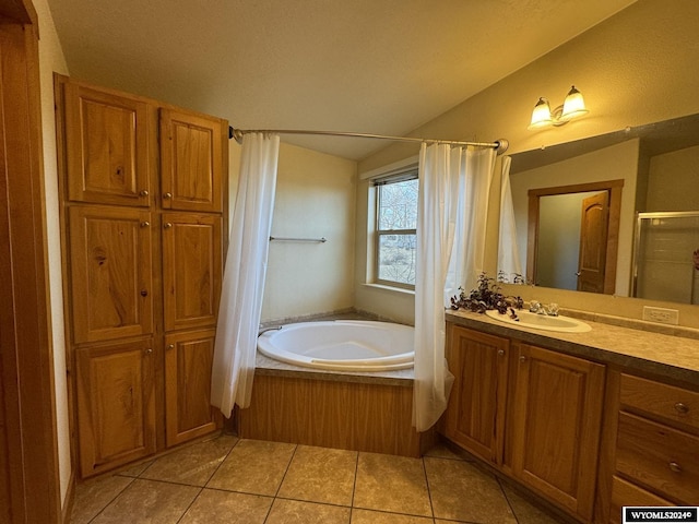 bathroom featuring plus walk in shower, tile patterned flooring, a textured ceiling, lofted ceiling, and vanity