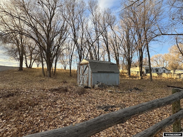 view of yard with a rural view and a shed