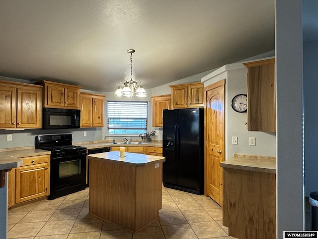 kitchen with a center island, lofted ceiling, black appliances, light tile patterned floors, and a chandelier