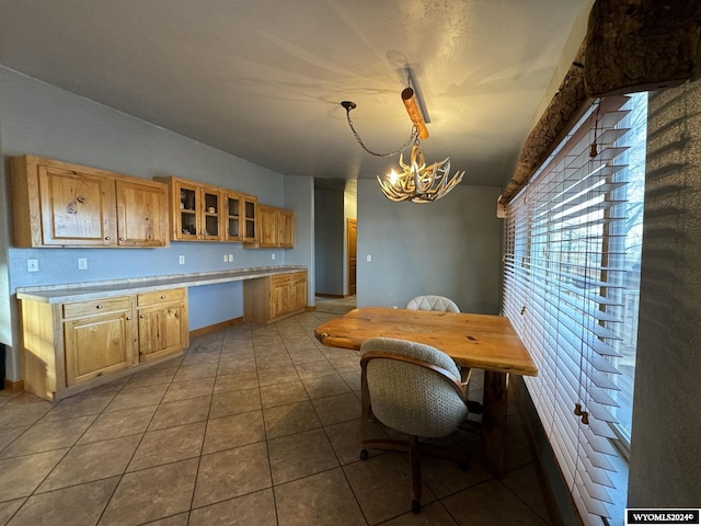 kitchen featuring tile patterned flooring, hanging light fixtures, and a notable chandelier