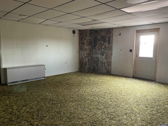 spare room featuring carpet and a paneled ceiling