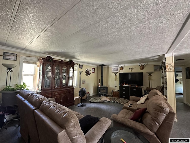 living room featuring a wood stove, crown molding, and a textured ceiling