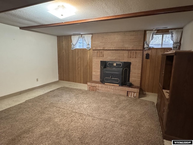 unfurnished living room with carpet floors, wooden walls, and a textured ceiling