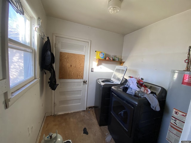 clothes washing area featuring washer and dryer and gas water heater