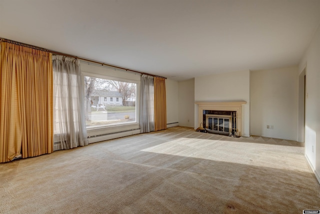 unfurnished living room featuring baseboard heating and light carpet