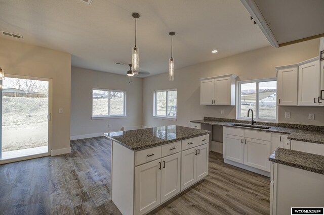 600 Badger Ln, Mills, WY 82644 - kitchen featuring white cabinetry, sink, and a wealth of natural light