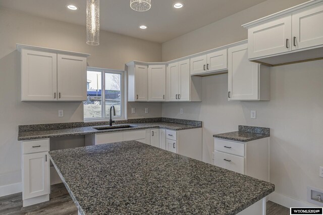 600 Badger Ln, Mills, WY 82644 - kitchen featuring white cabinets, decorative light fixtures, dark hardwood / wood-style floors, and sink