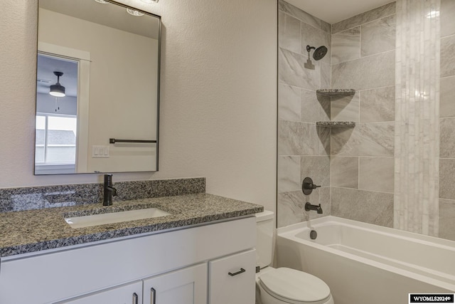 full bathroom featuring vanity, toilet, and tiled shower / bath