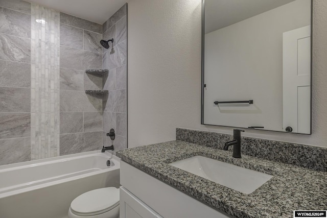 full bathroom featuring vanity, toilet, and tiled shower / bath