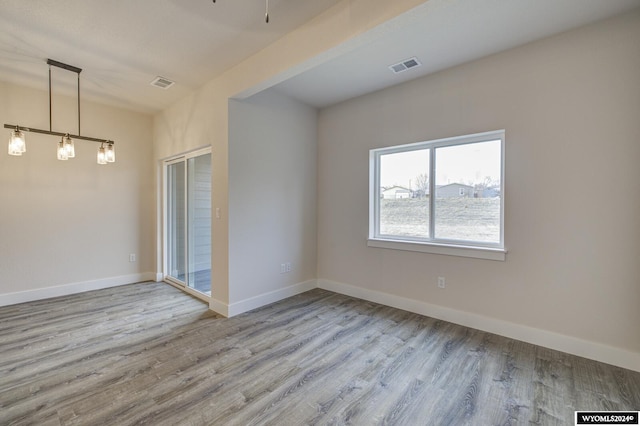 unfurnished room with light wood-type flooring