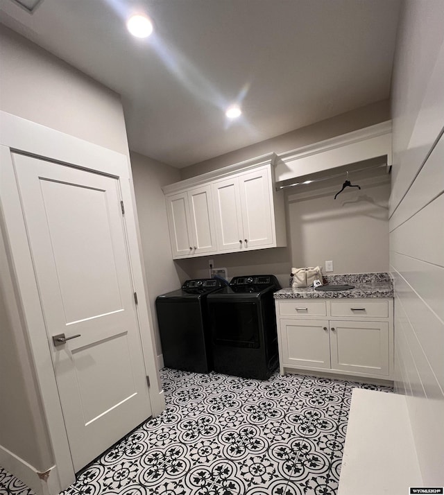 laundry area featuring washing machine and dryer, light tile patterned flooring, cabinet space, and recessed lighting