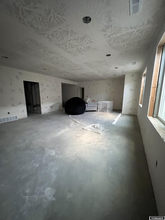 interior space featuring visible vents and unfinished concrete floors