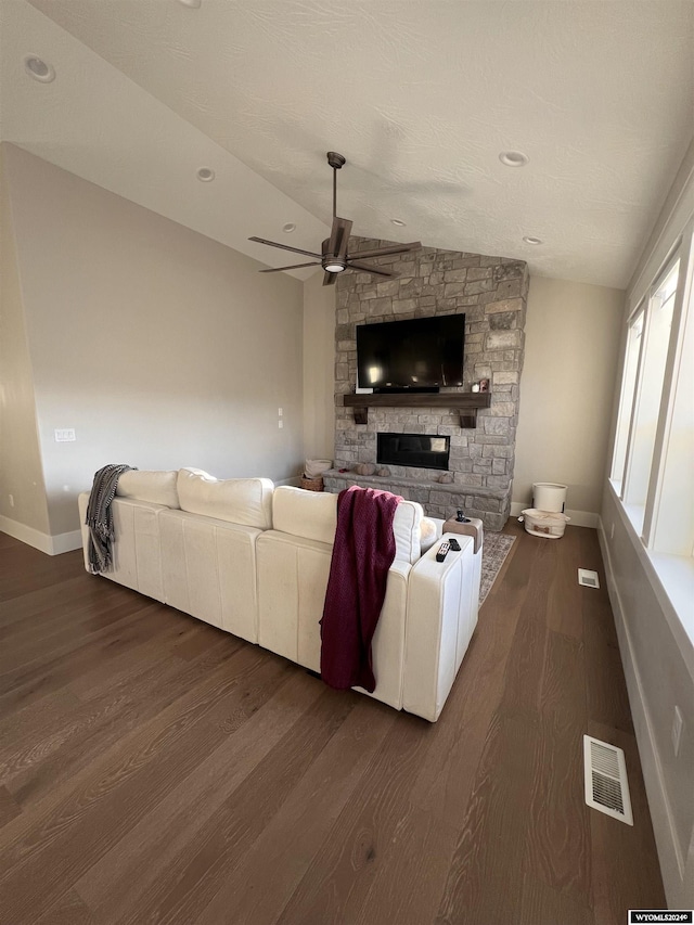 living room featuring visible vents, a ceiling fan, baseboards, lofted ceiling, and dark wood-style flooring