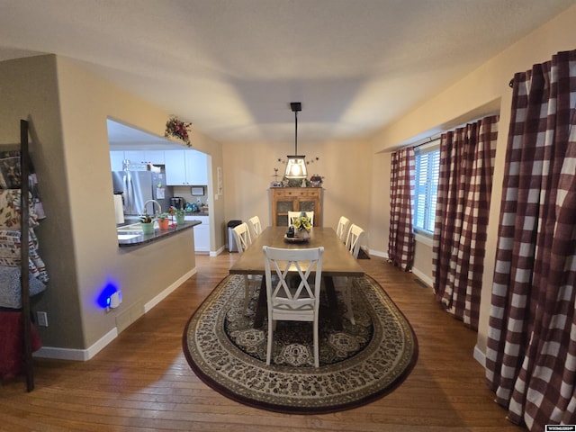 dining space with wood-type flooring