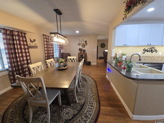 dining space featuring dark hardwood / wood-style flooring and sink